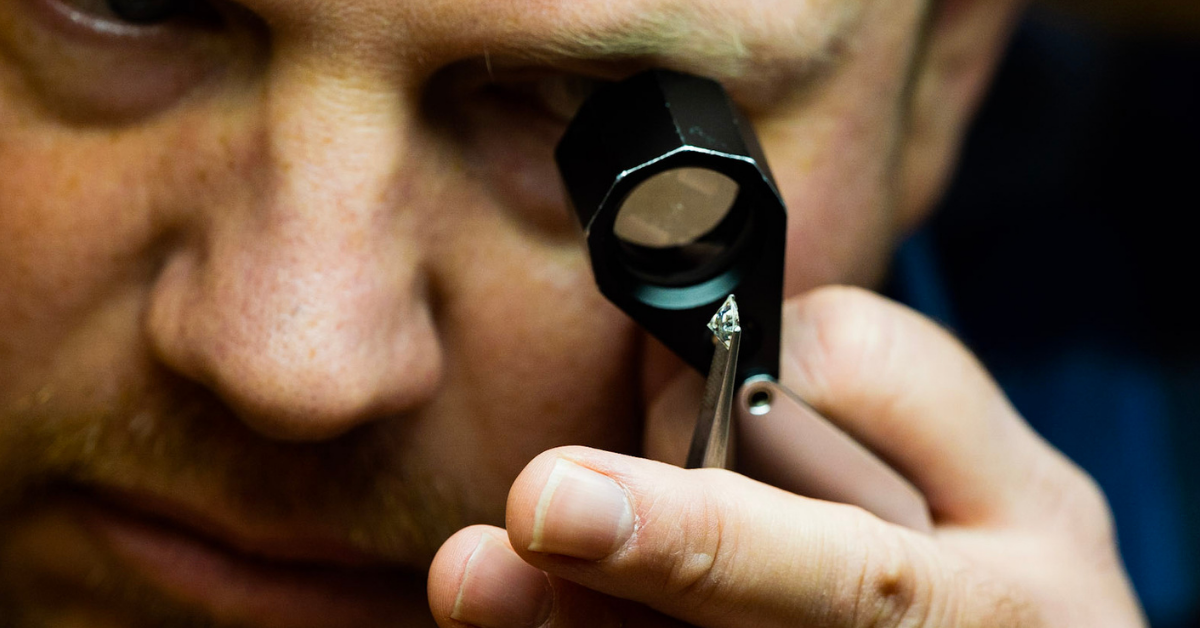 Jeweler looking at a diamond through a loupe